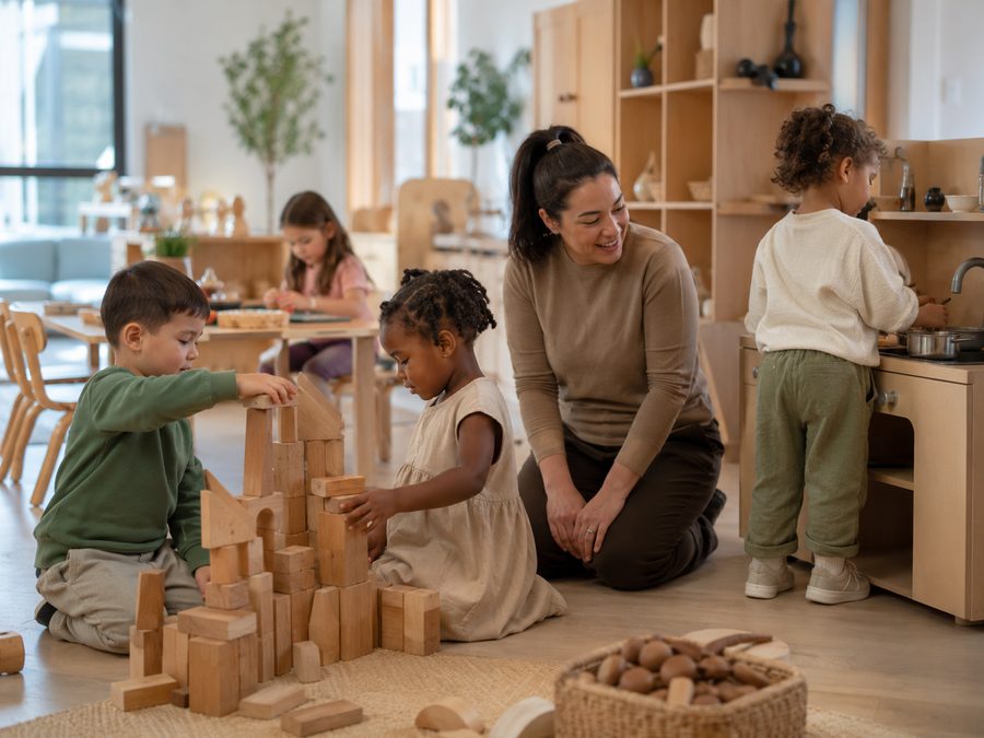 Toddlers building with wooden blocks